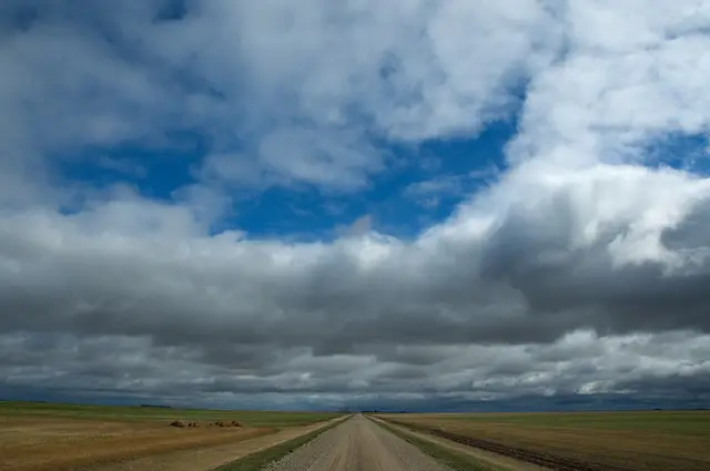 Gravel road across the prairie under big sky